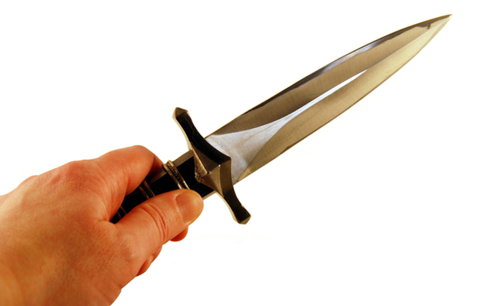 Dagger in hand held forward pointing to the right