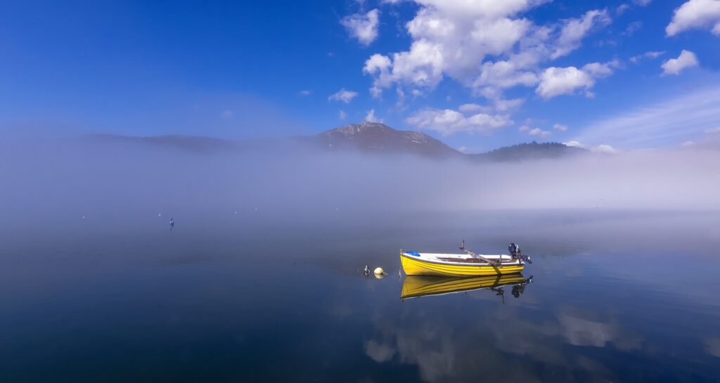 Boat on foggy lake